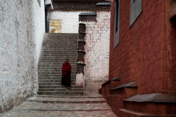 woman in red dress standing on stairs